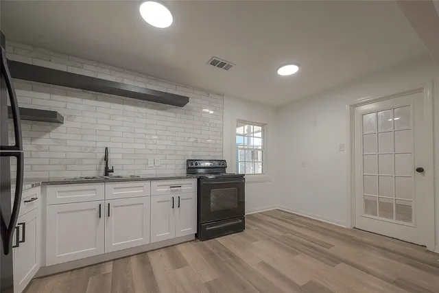a kitchen with a sink stove and cabinets
