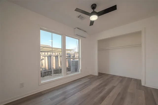wooden floor in an empty room with a window