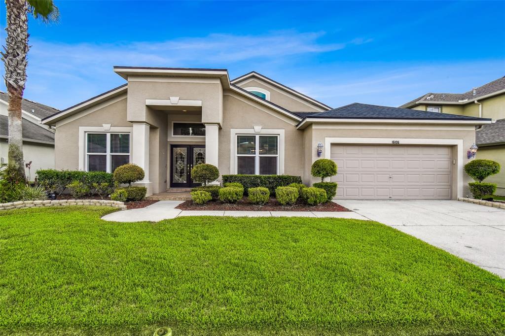 16106 Rambling Road Odessa, FL 33556 - Photo 1 of 1 a front view of a house with a yard and garage