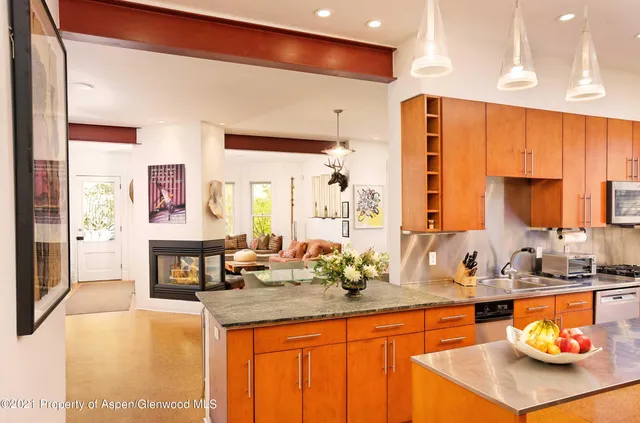 a kitchen with stainless steel appliances a sink and a refrigerator