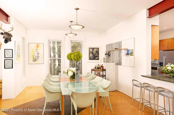 a view of a dining room with furniture and chandelier