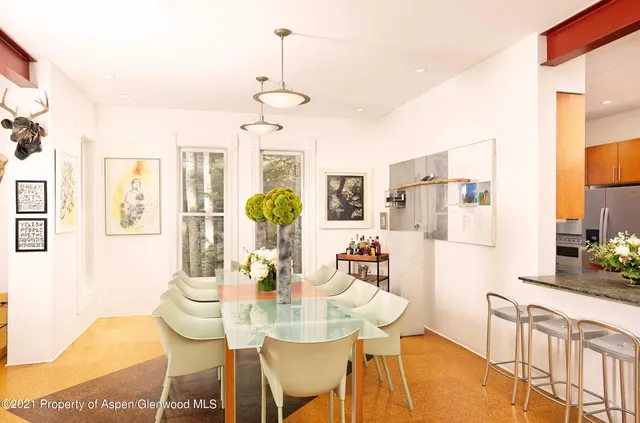 a view of a dining room with furniture and chandelier