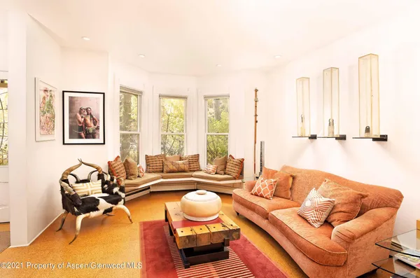 a living room with furniture and large windows