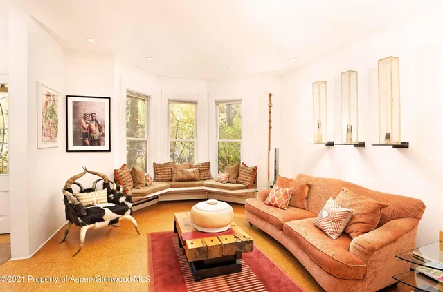 a living room with furniture and large windows