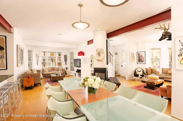 a living room with fireplace furniture and a large window