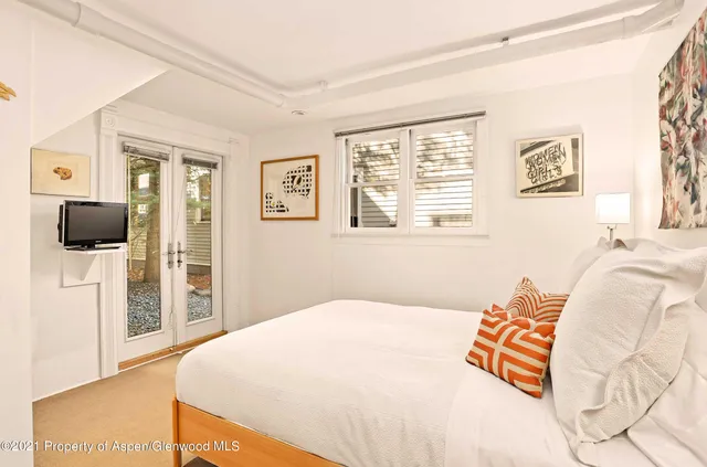 a bedroom with a bed and a television