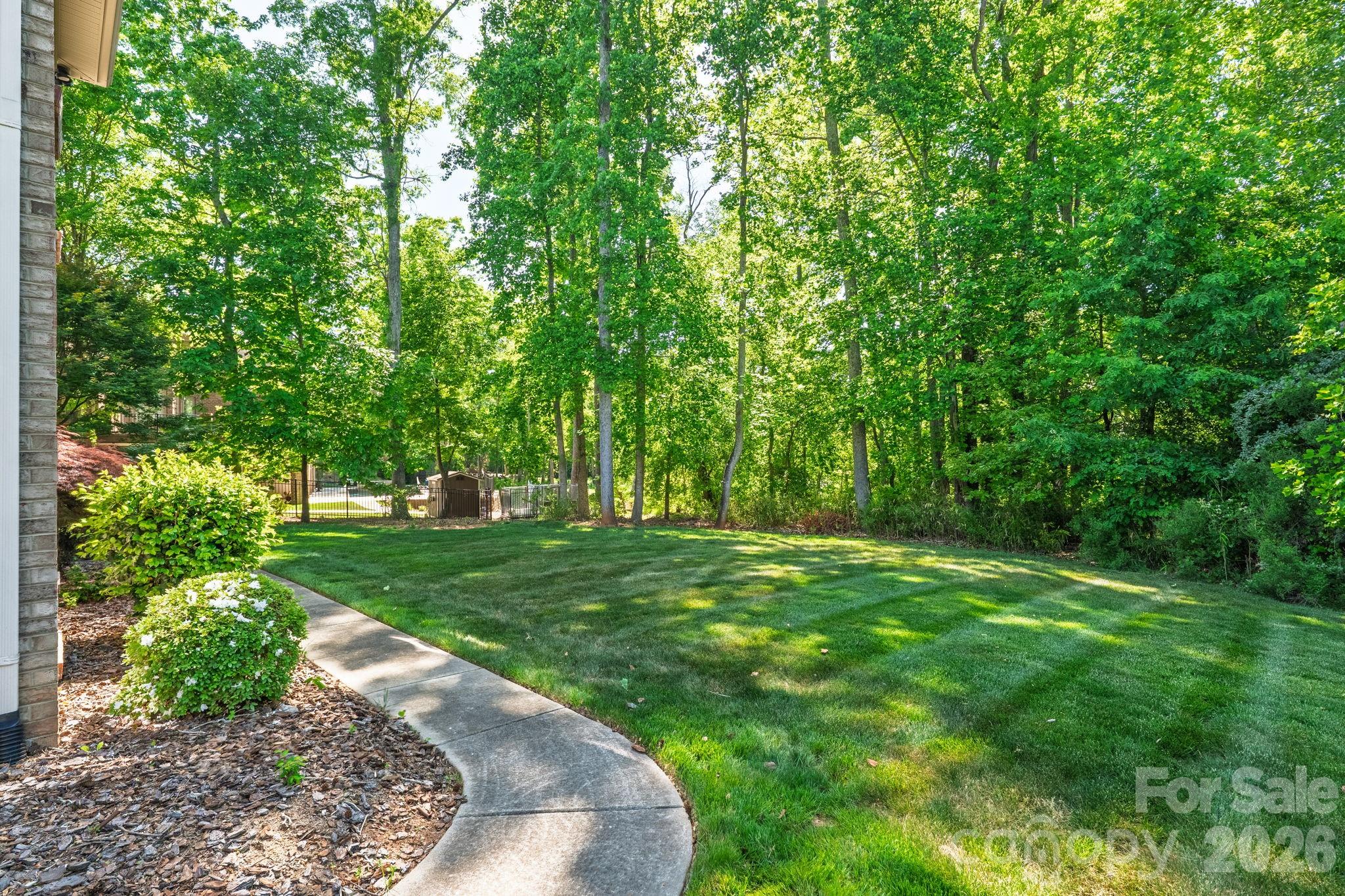 3138 Rappahannock Court, Unit 16 Matthews, NC 28104 - Photo 8 of 38 a view of a backyard with a garden