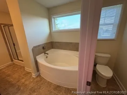 a white bath tub sitting next to a toilet