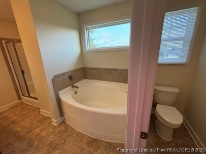 5407 Nessee Street Fayetteville, NC 28314 - Photo 15 of 22 a white bath tub sitting next to a toilet