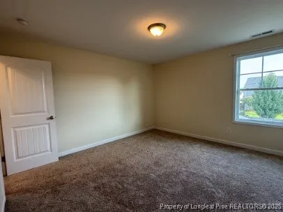 an empty room with a empty space and windows
