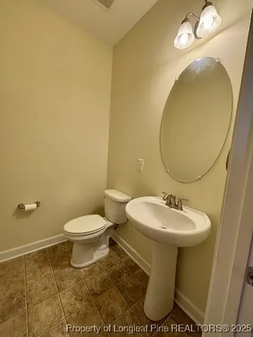 a bathroom with a sink toilet and mirror