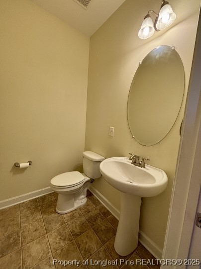 5407 Nessee Street Fayetteville, NC 28314 - Photo 21 of 22 a bathroom with a sink toilet and mirror