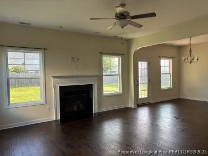 a view of an empty room with exposed radiator and fireplace