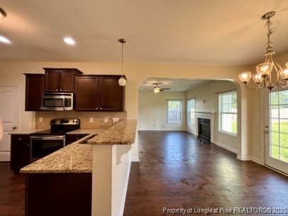 5407 Nessee Street Fayetteville, NC 28314 - Photo 7 of 22 a kitchen with stainless steel appliances kitchen island granite countertop a sink counter space and cabinets