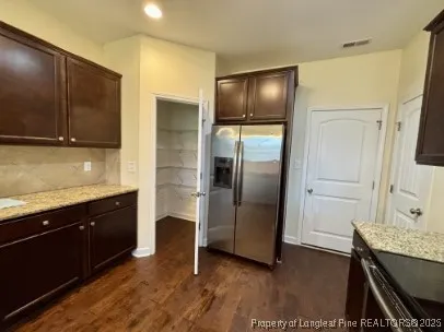 a kitchen with granite countertop stainless steel appliances and wooden cabinets