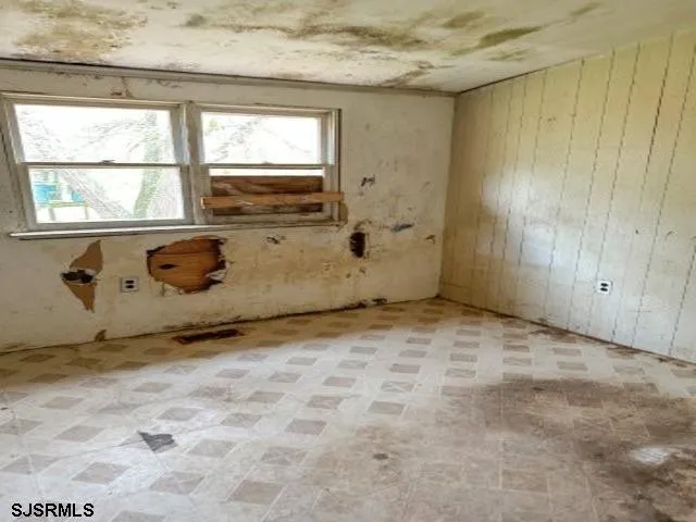 a view of an empty room with a fireplace