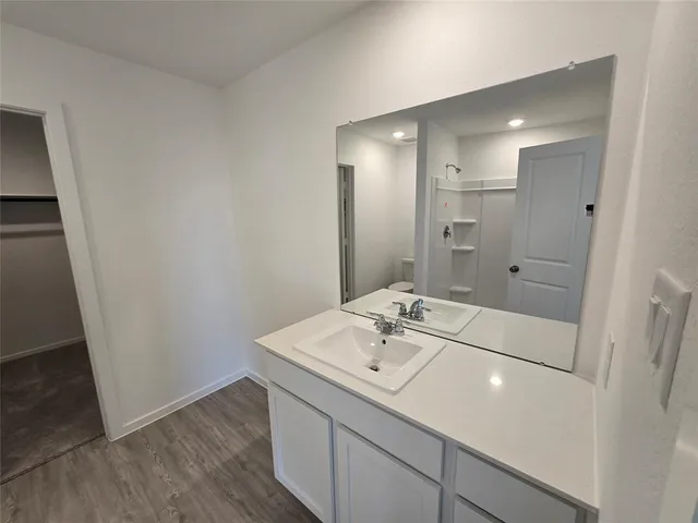 a bathroom with a sink a shower and a mirror