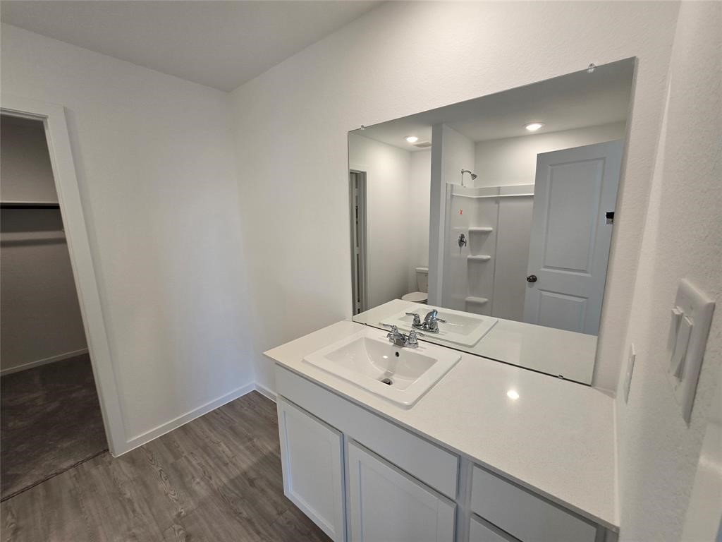 406 Nicholas Road Wharton, TX 77488 - Photo 10 of 18 a bathroom with a sink a shower and a mirror