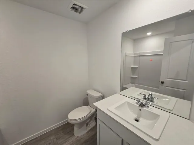 a bathroom with a sink a toilet and mirror