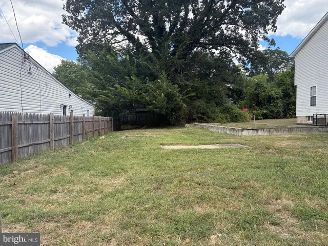 a view of a backyard with large trees