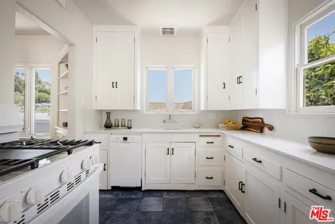 a kitchen with sink a washer and dryer