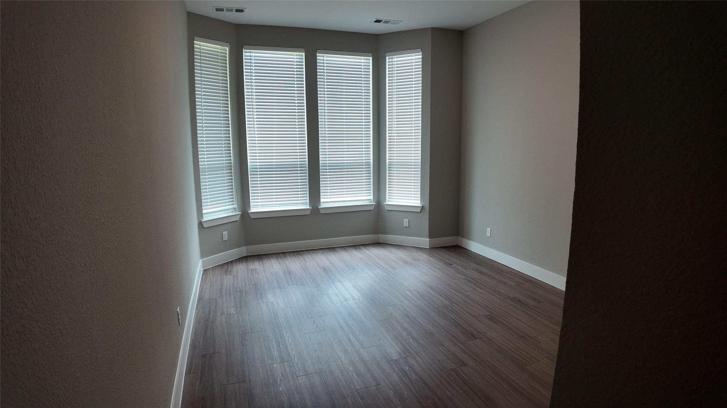 512 Brockwell Bend Forney, TX 75126 - Photo 13 of 35 an empty room with wooden floor and windows