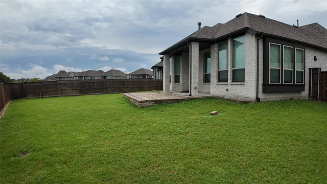 a view of a house with a yard and sitting area