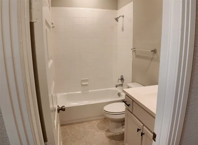 a bathroom with a toilet and a bath tub