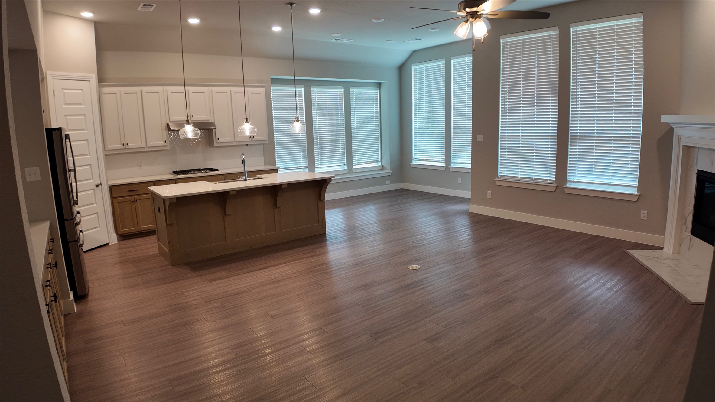512 Brockwell Bend Forney, TX 75126 - Photo 5 of 35 a large kitchen with stainless steel appliances a large counter top a wooden floors and a large window
