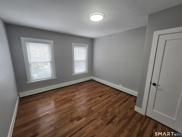 a view of a room with wooden floor
