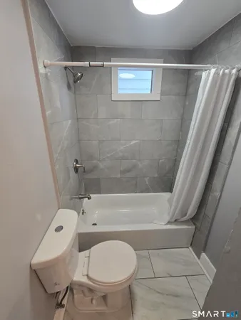 a bathroom with a toilet and a bathtub