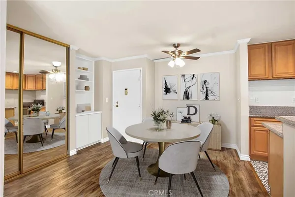 a view of a dining room with furniture a chandelier and wooden floor