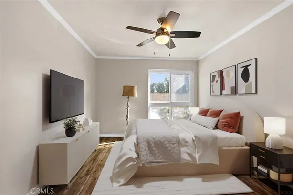 a bedroom with a bed window and a flat screen tv
