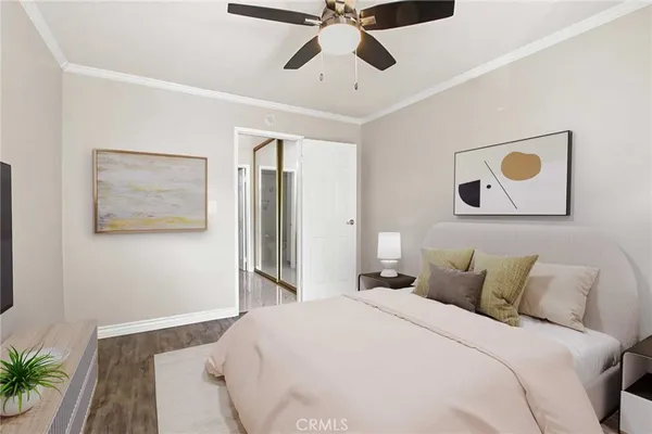 a bedroom with a bed and a painting on the wall