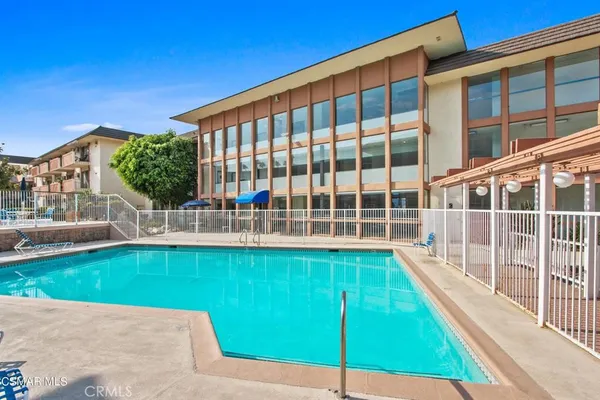 a view of swimming pool with a garden and deck
