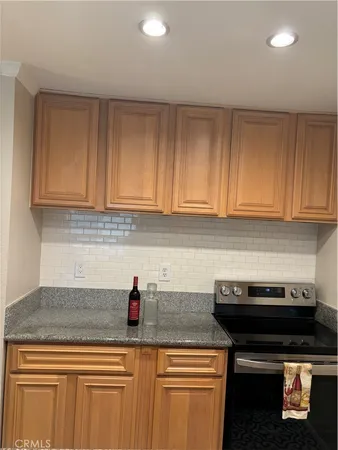 a kitchen with stainless steel appliances granite countertop a sink a stove and cabinets
