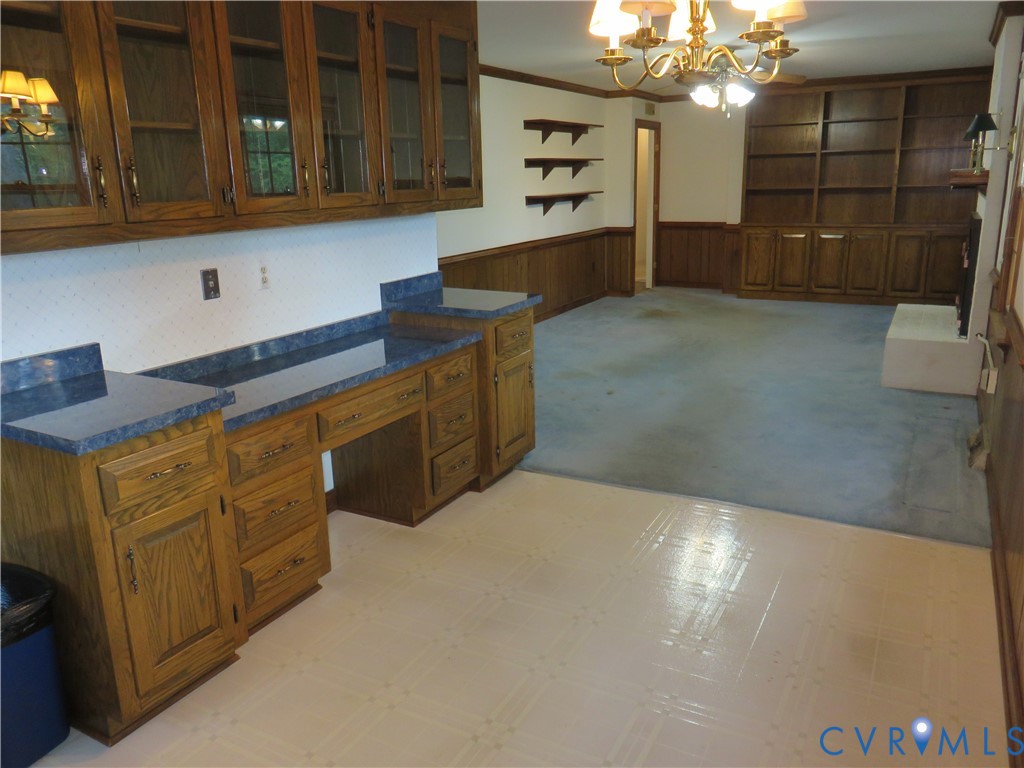 8379 Quailfield Road Mechanicsville, VA 23116 - Photo 25 of 56 a kitchen with cabinets and wooden floor