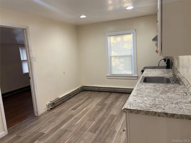 a view of a kitchen that shows a sink storage and utility