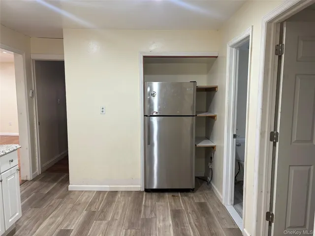 a view of a hallway with wooden floor and closet area