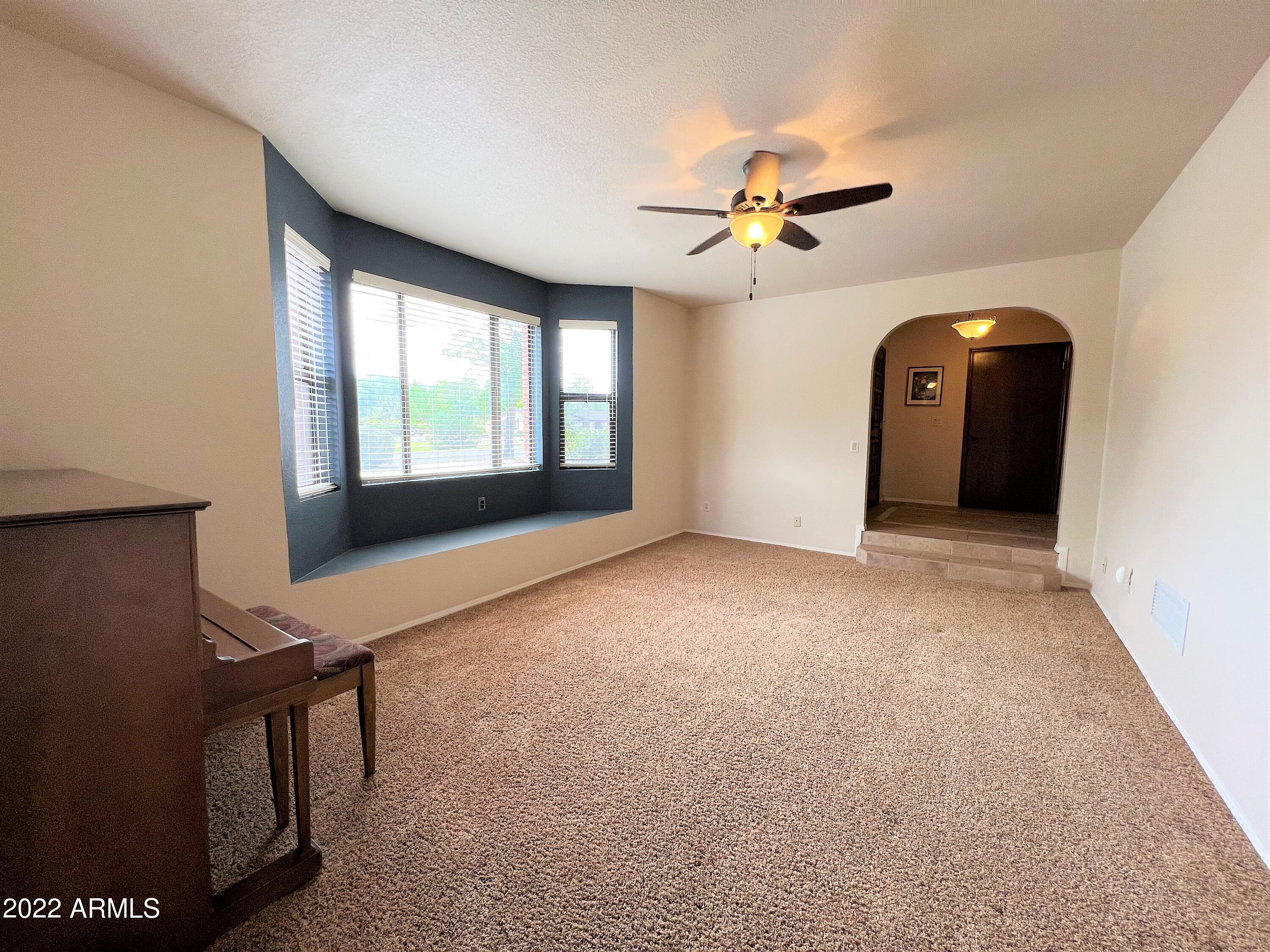 16502 West Magnolia Street Goodyear, AZ 85338 - Photo 12 of 59 a view of a livingroom with a ceiling fan and window