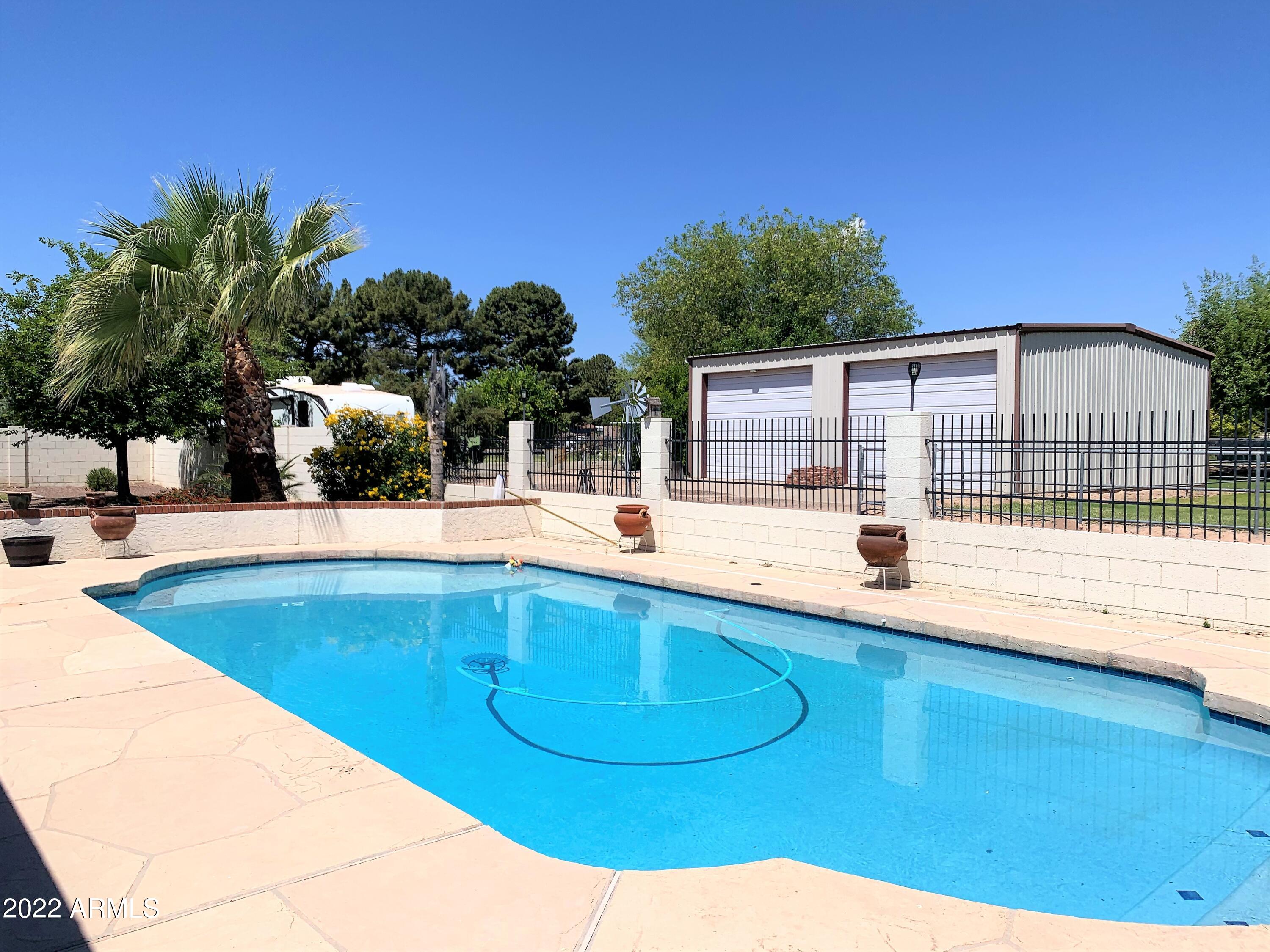 16502 West Magnolia Street Goodyear, AZ 85338 - Photo 14 of 59 a view of a swimming pool with a patio