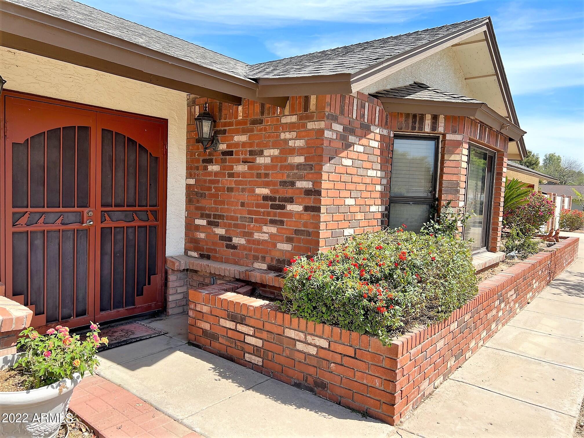 16502 West Magnolia Street Goodyear, AZ 85338 - Photo 2 of 59 a front view of a house