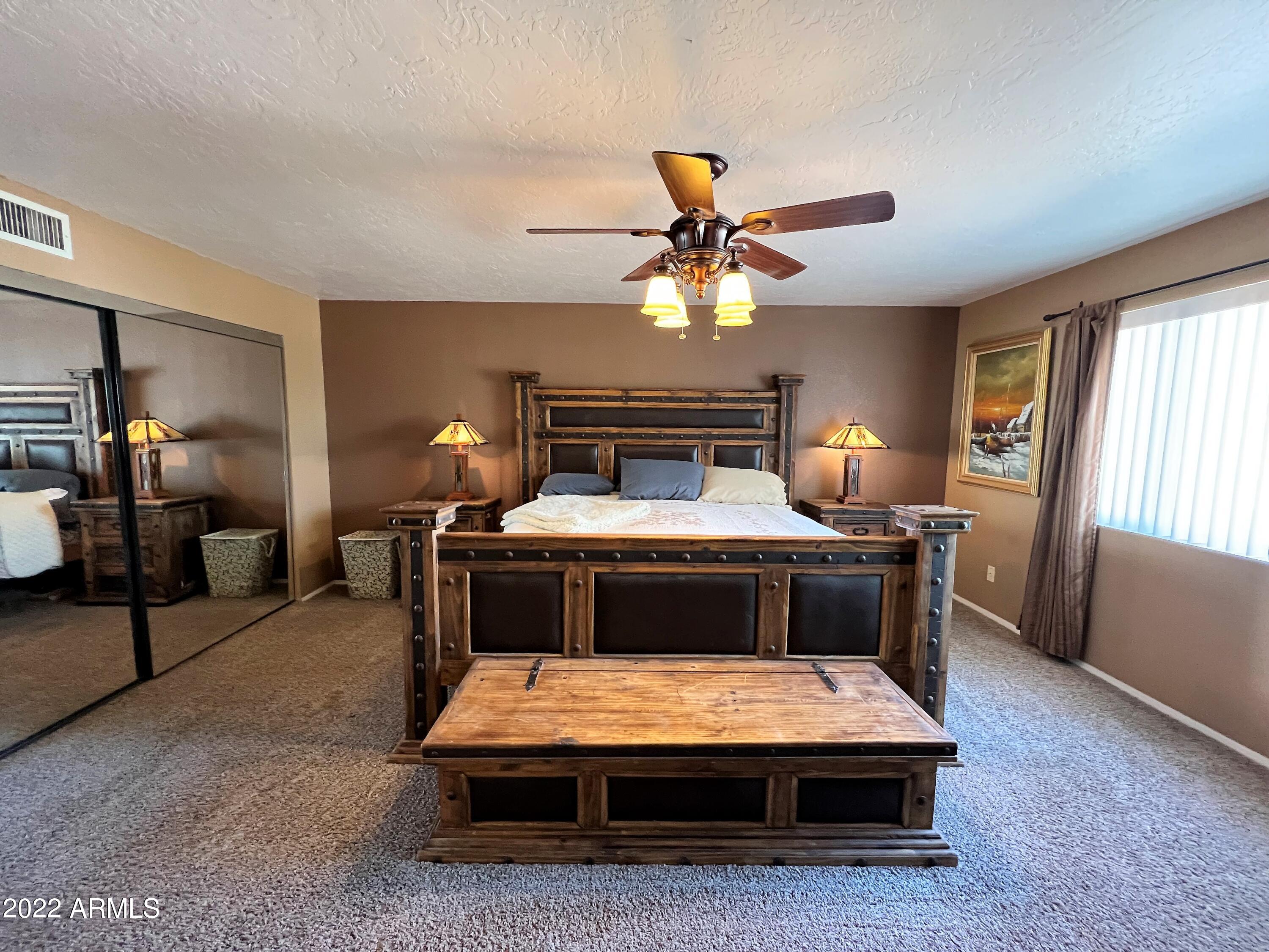 16502 West Magnolia Street Goodyear, AZ 85338 - Photo 21 of 59 a bedroom with a bed and window
