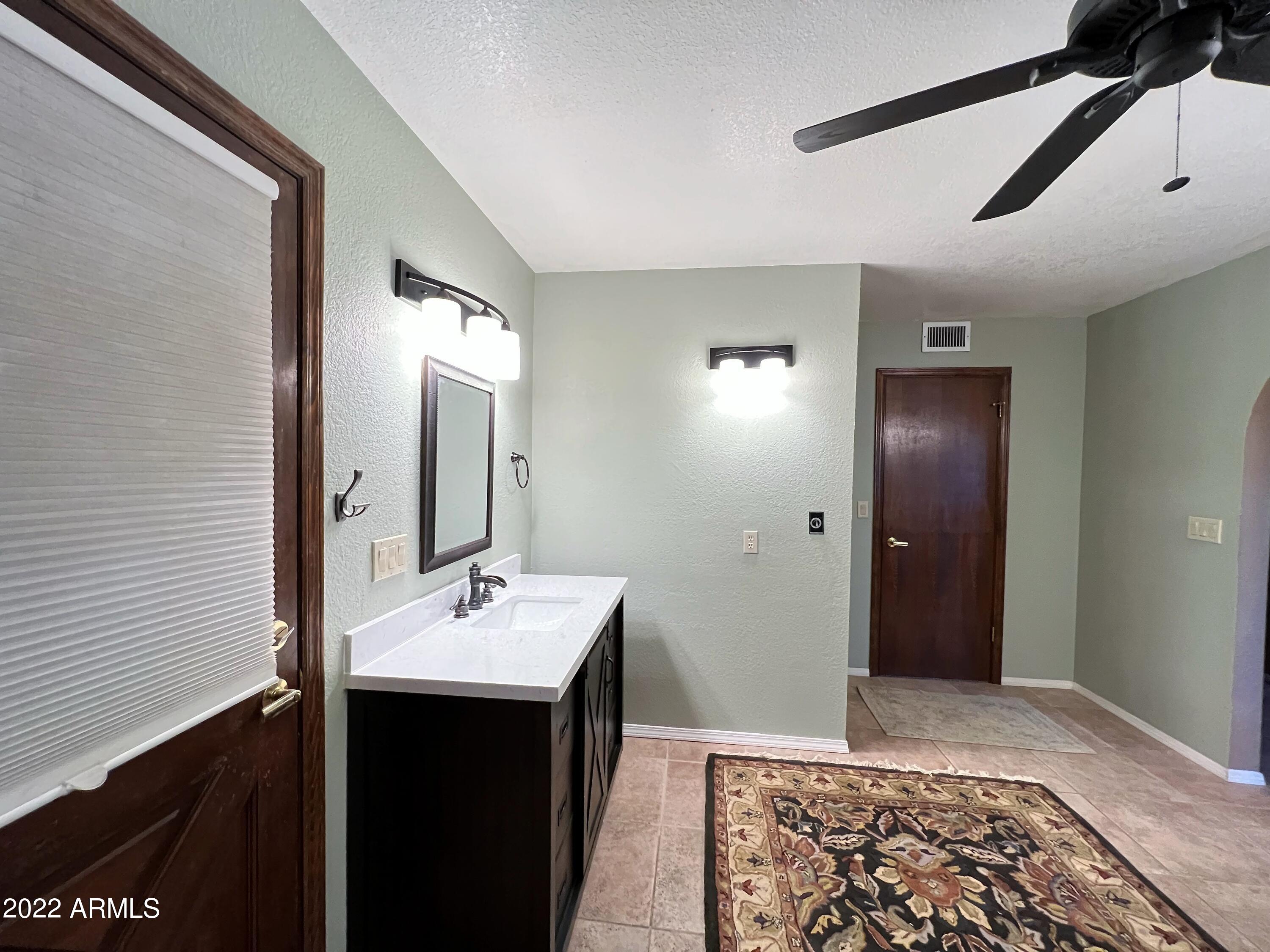16502 West Magnolia Street Goodyear, AZ 85338 - Photo 27 of 59 a bathroom with a sink and a mirror