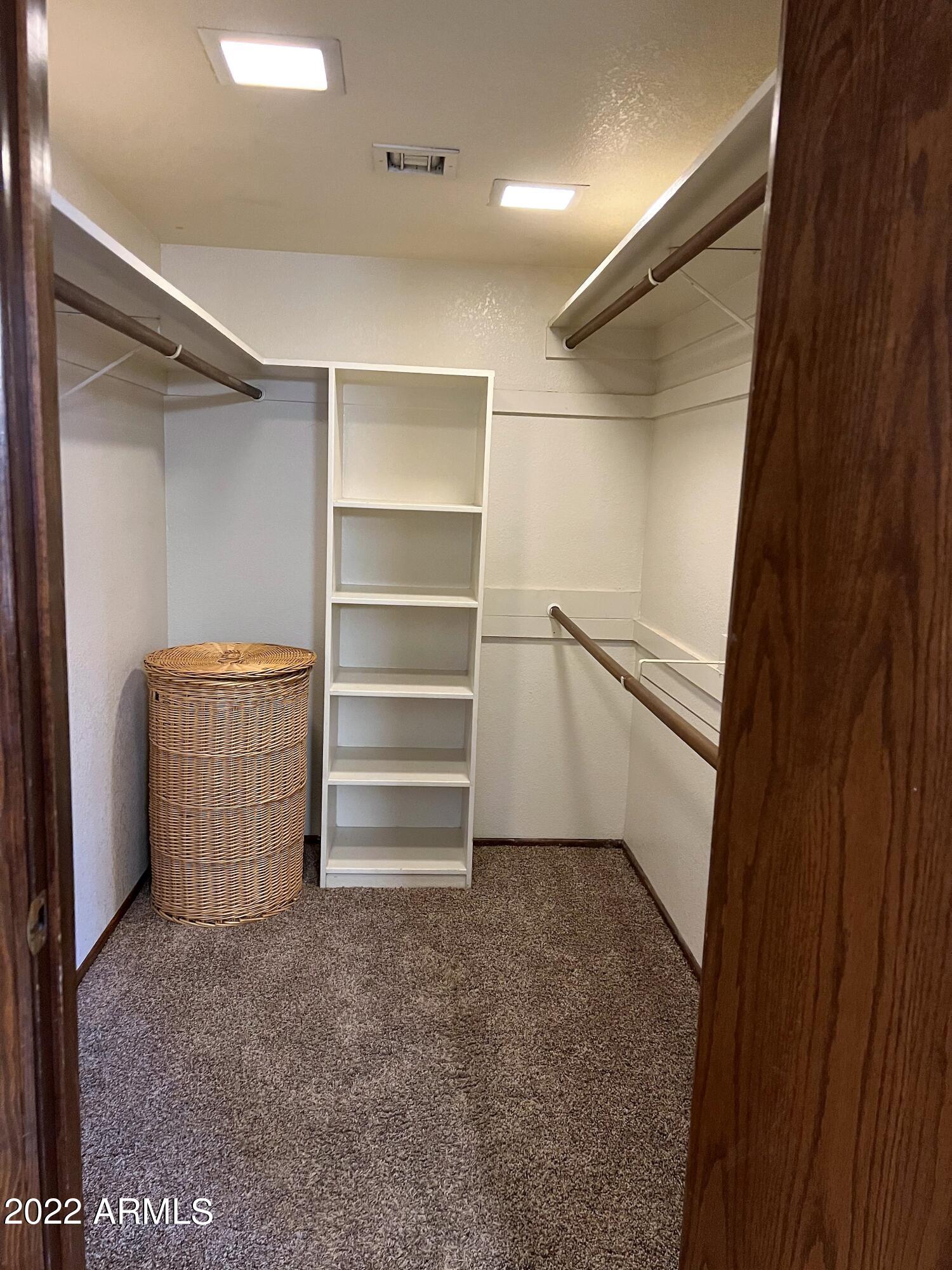 16502 West Magnolia Street Goodyear, AZ 85338 - Photo 28 of 59 a view of walk in closet with empty racks