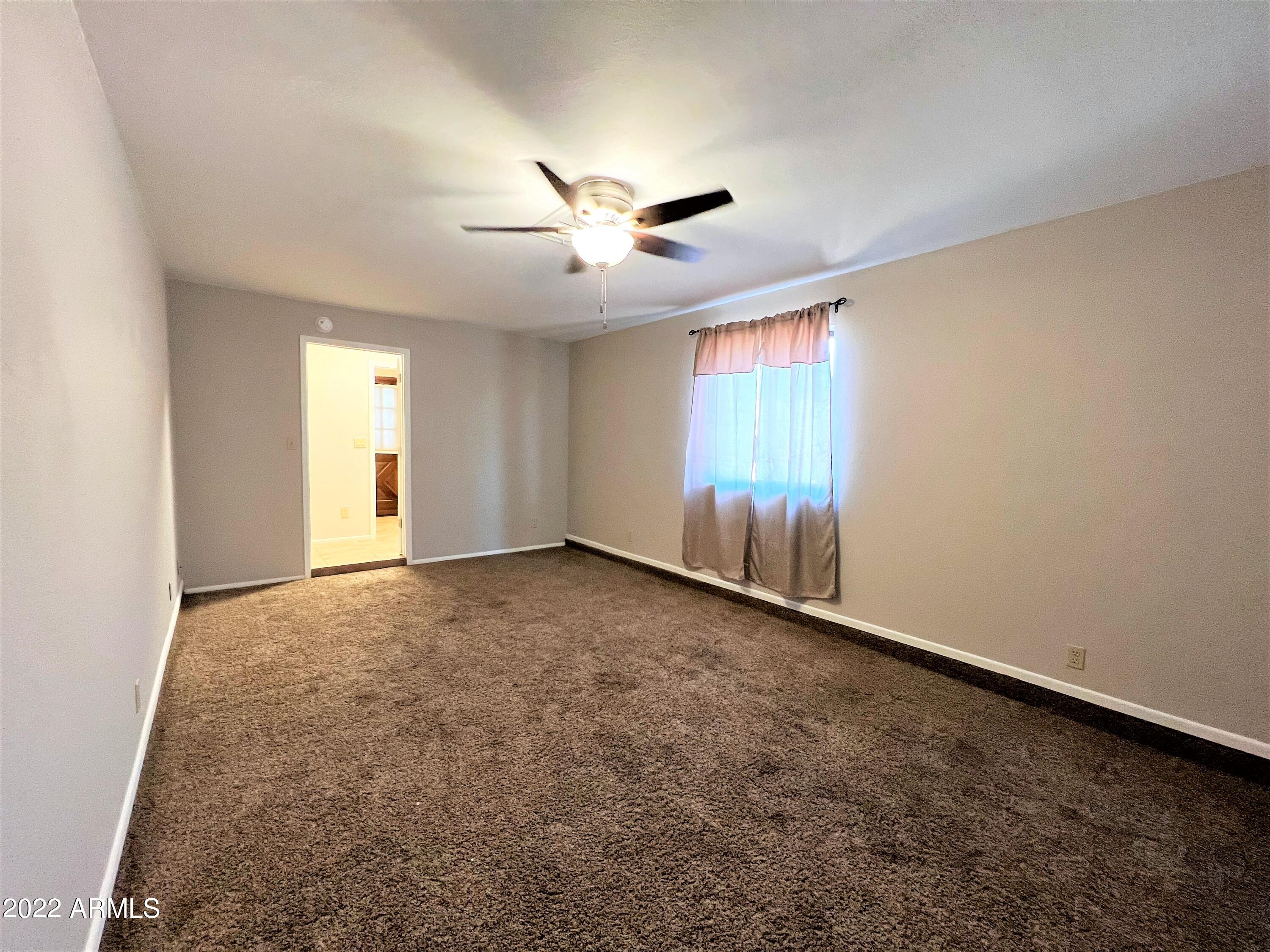 16502 West Magnolia Street Goodyear, AZ 85338 - Photo 29 of 59 wooden floor in an empty room with a window
