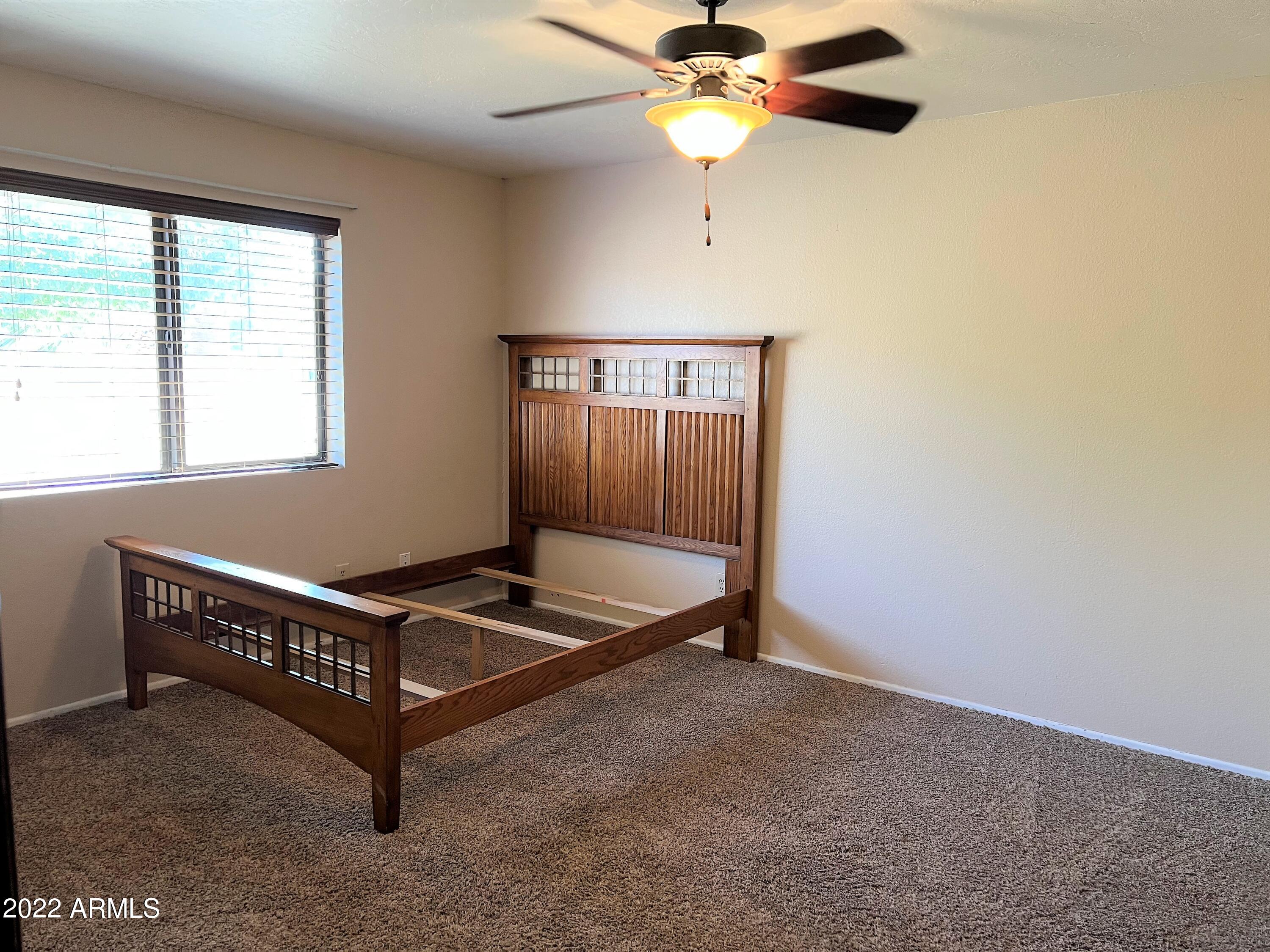 16502 West Magnolia Street Goodyear, AZ 85338 - Photo 35 of 59 a room with a window and ceiling fan