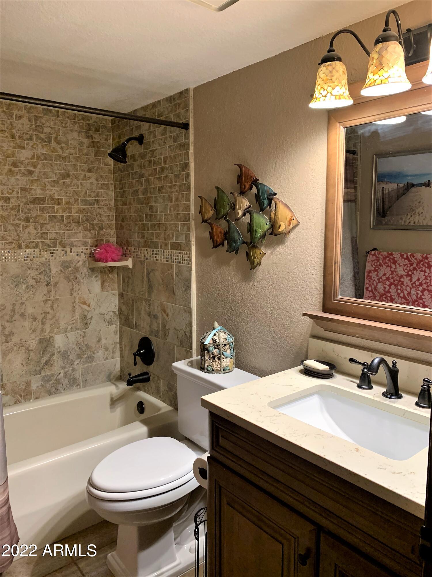 16502 West Magnolia Street Goodyear, AZ 85338 - Photo 39 of 59 a bathroom with a sink toilet and shower