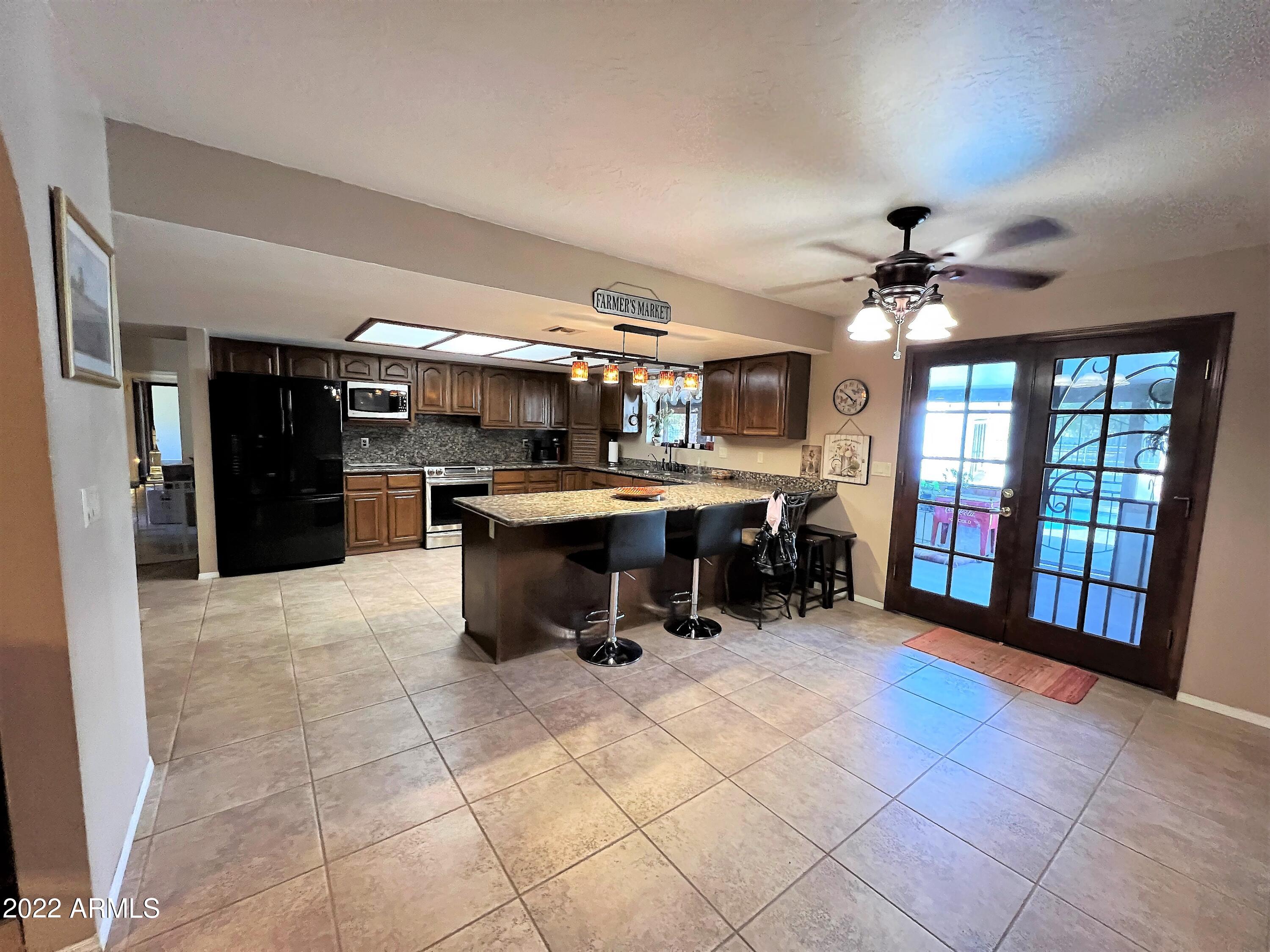 16502 West Magnolia Street Goodyear, AZ 85338 - Photo 4 of 59 a room with lots of furniture and chandelier