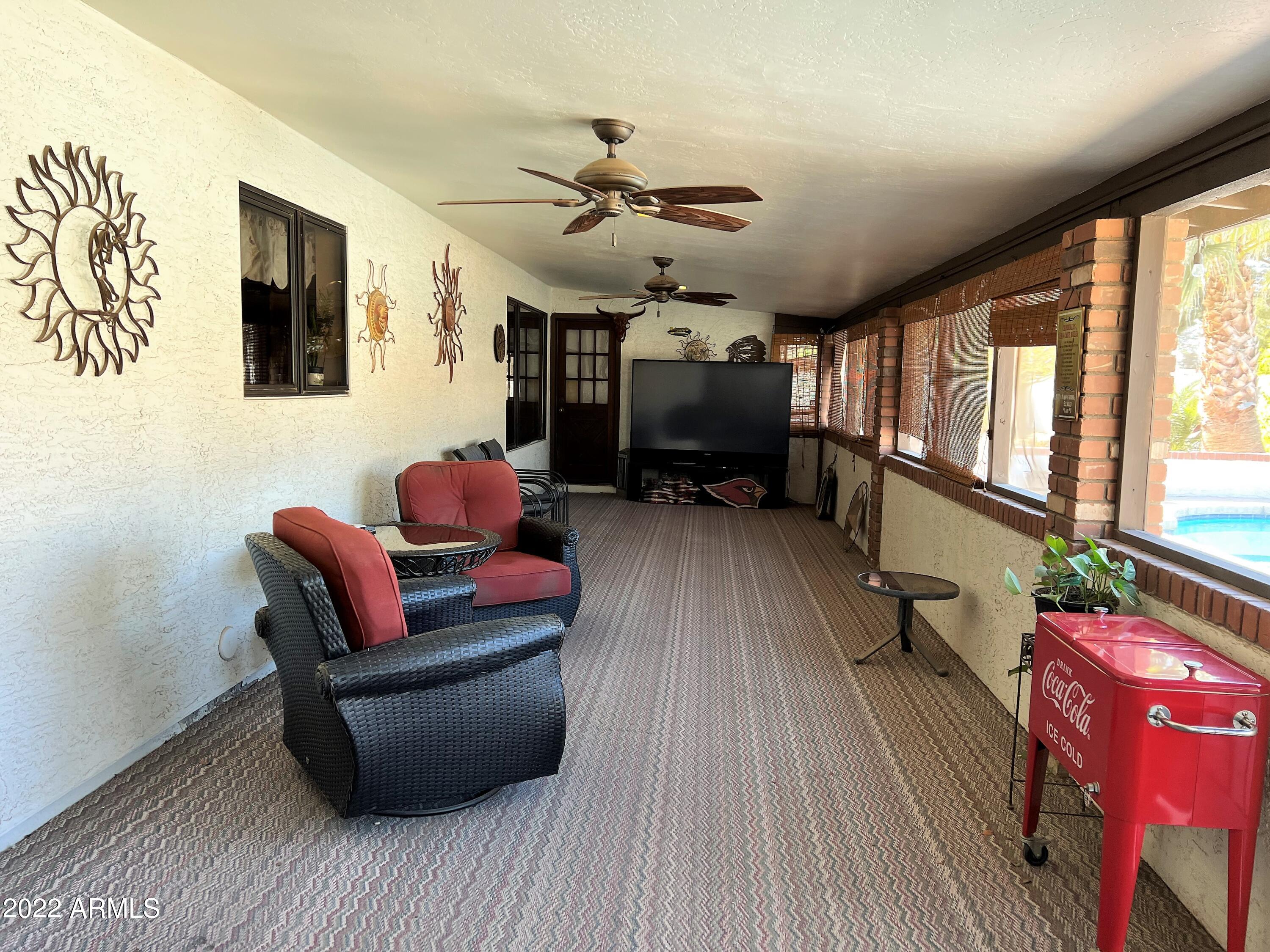 16502 West Magnolia Street Goodyear, AZ 85338 - Photo 42 of 59 a living room with furniture and a flat screen tv